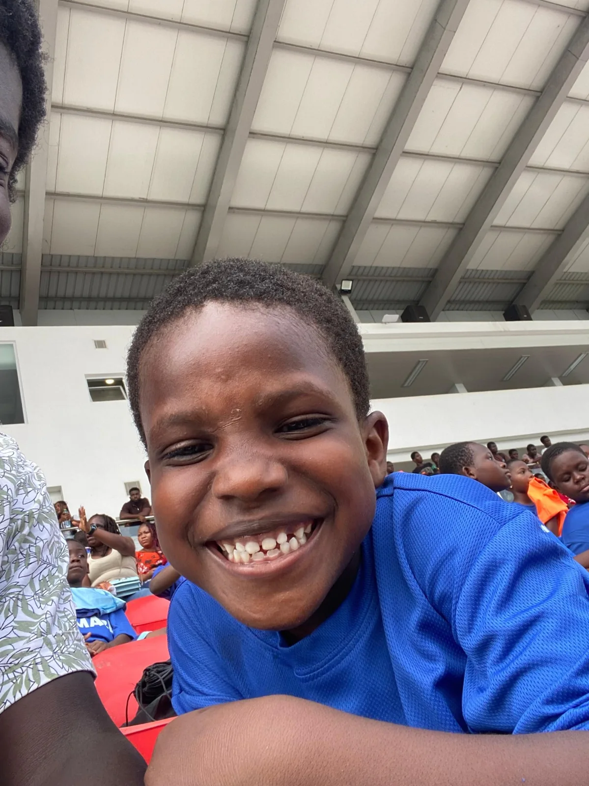 A child with a big smile at the community event.