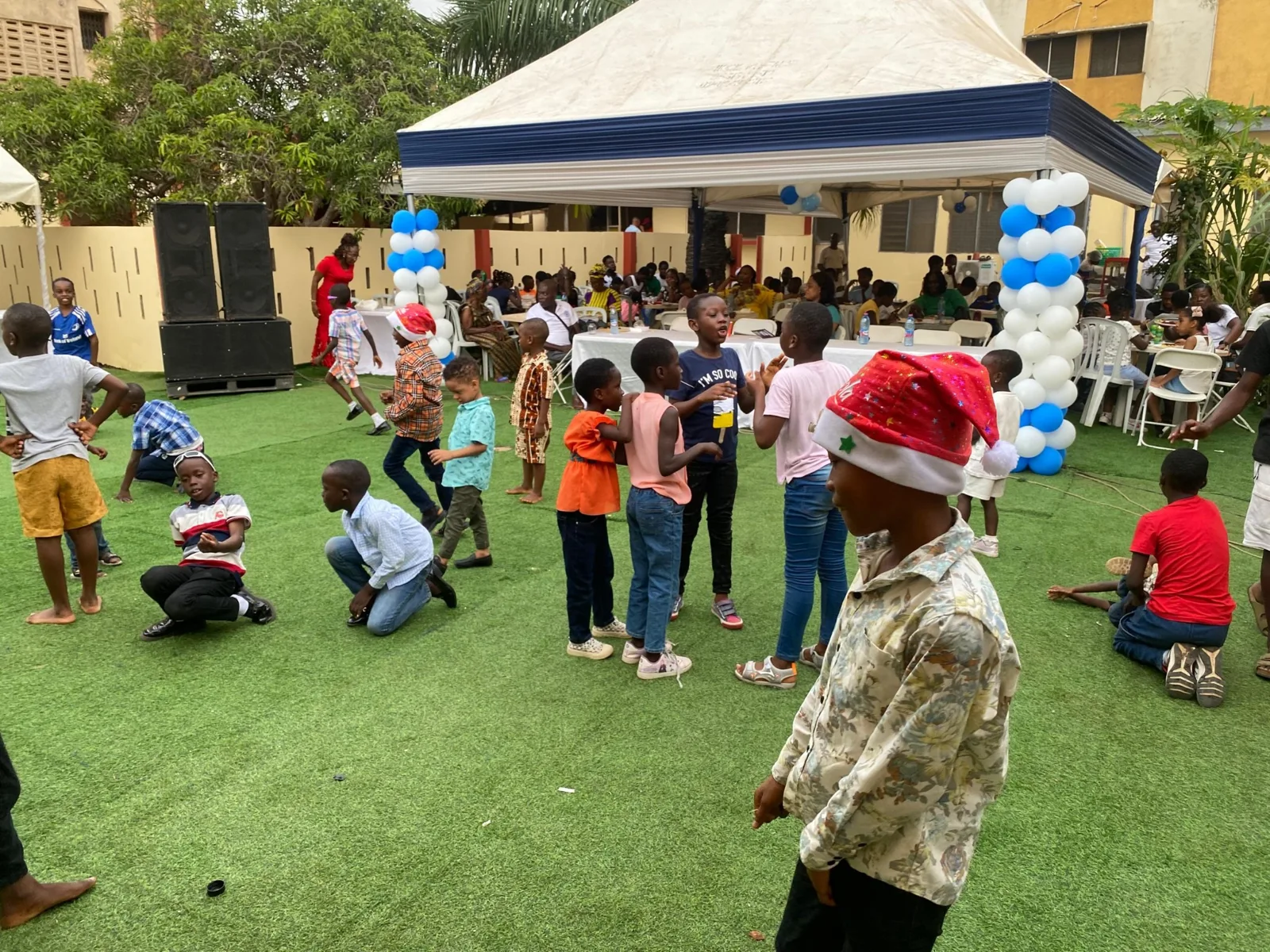 Children taking part in activities beside event canopies.